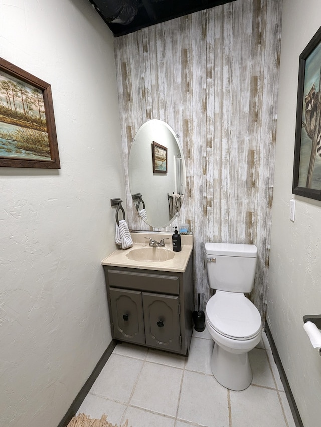 bathroom with tile patterned flooring, vanity, and toilet