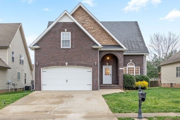 view of front facade featuring a garage and a front lawn