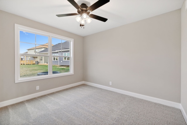 spare room with ceiling fan and carpet floors