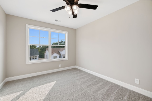 carpeted empty room featuring ceiling fan