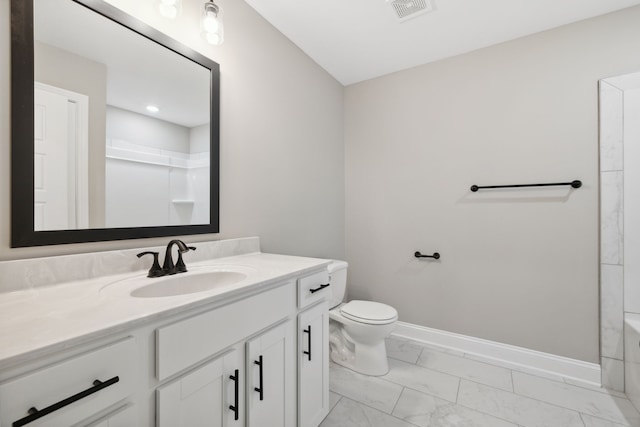 bathroom featuring vanity and toilet