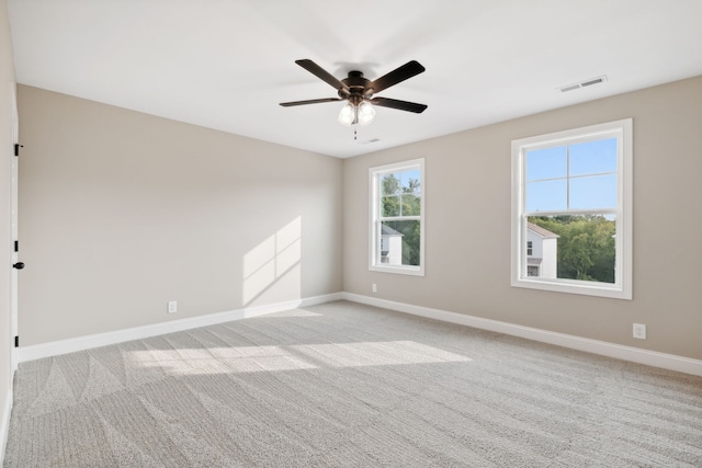 empty room featuring light carpet and ceiling fan