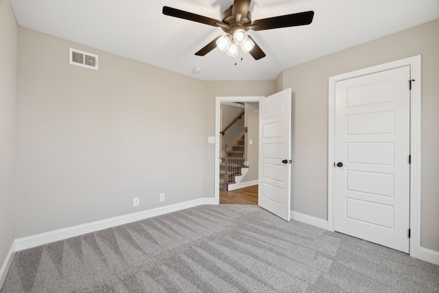 unfurnished bedroom with ceiling fan and light carpet