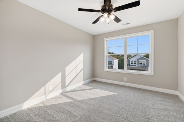 carpeted spare room with ceiling fan