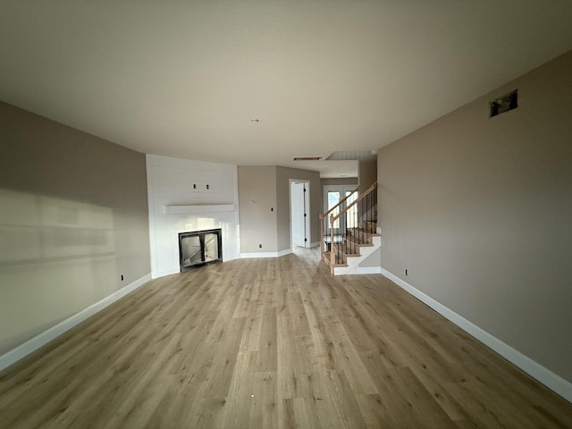 unfurnished living room with light wood-type flooring