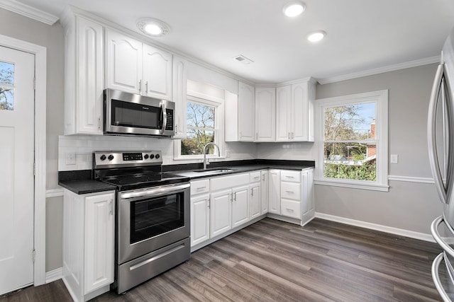 kitchen featuring white cabinetry, stainless steel appliances, and a healthy amount of sunlight