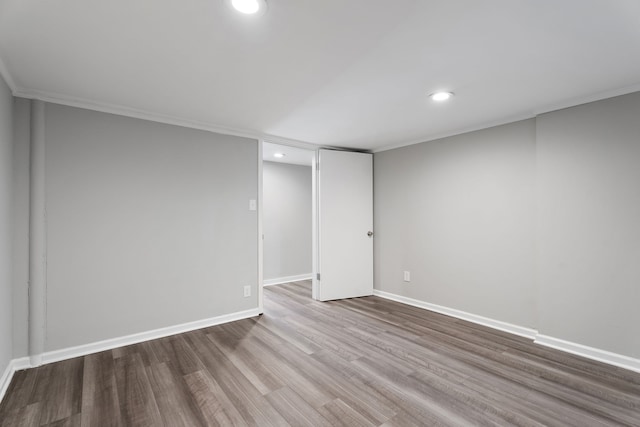 empty room with crown molding and hardwood / wood-style floors