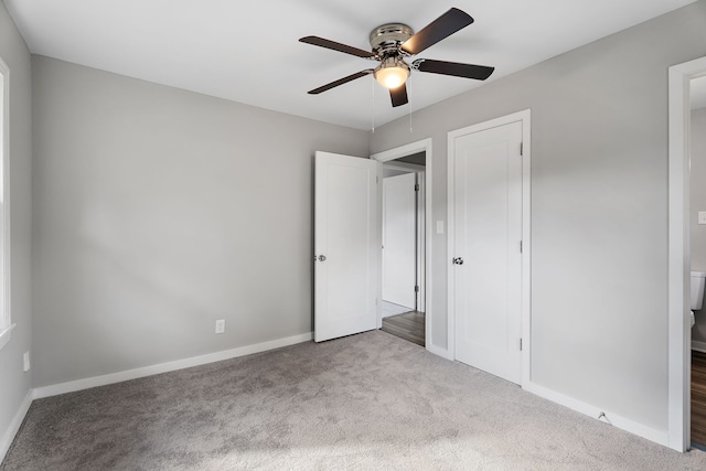 unfurnished bedroom with a closet, light colored carpet, and ceiling fan