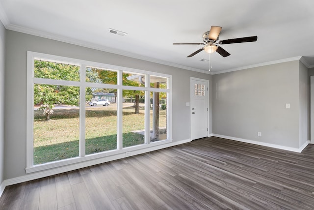 empty room with ceiling fan, ornamental molding, and dark hardwood / wood-style floors