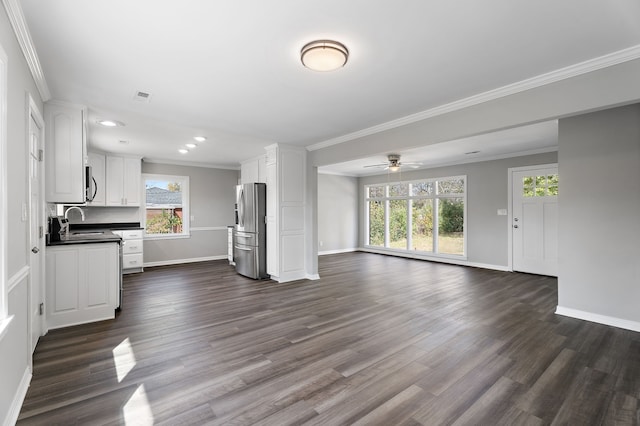 unfurnished living room with sink, ceiling fan, ornamental molding, and dark hardwood / wood-style flooring