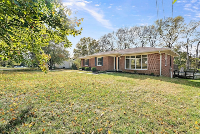 ranch-style home featuring a front yard and a deck