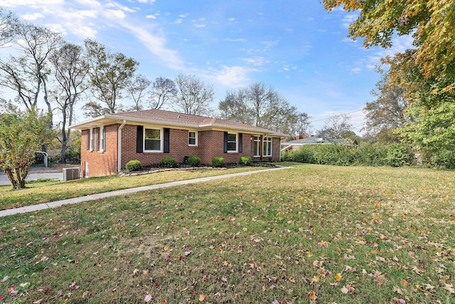 ranch-style home featuring central air condition unit and a front yard