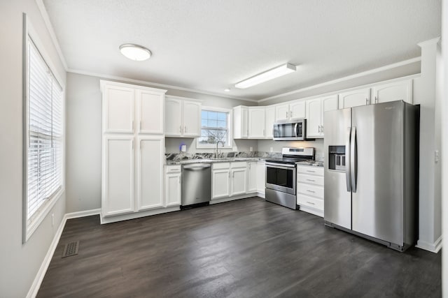 kitchen featuring white cabinets, dark wood-type flooring, and stainless steel appliances