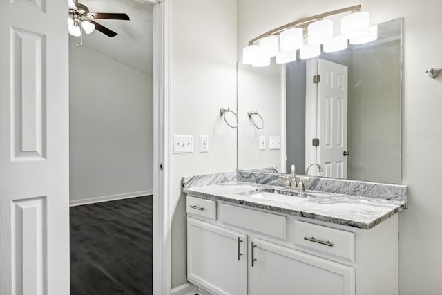 bathroom featuring wood-type flooring, vanity, and ceiling fan