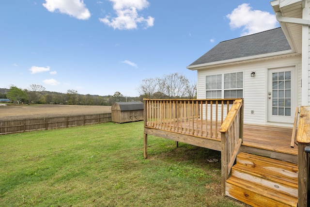 view of yard with a deck and a storage shed