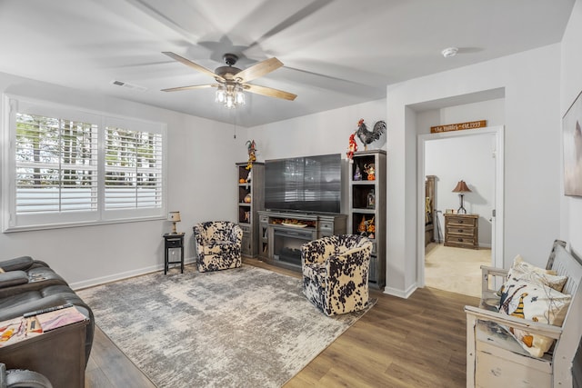 living room featuring hardwood / wood-style flooring and ceiling fan