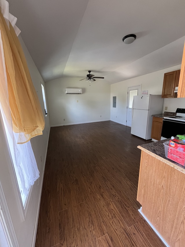 kitchen featuring vaulted ceiling, a wall unit AC, white appliances, and dark hardwood / wood-style flooring