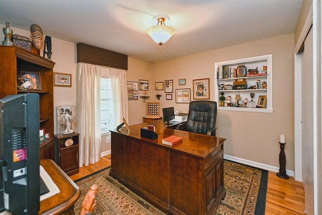 office with light hardwood / wood-style floors