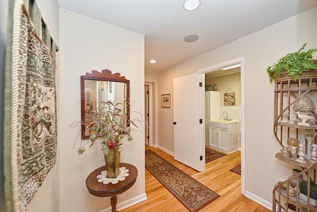 hallway with light hardwood / wood-style flooring