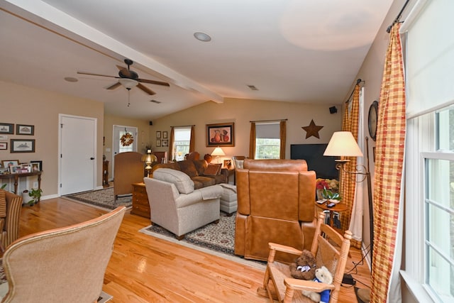 living room featuring light hardwood / wood-style flooring, lofted ceiling with beams, and ceiling fan