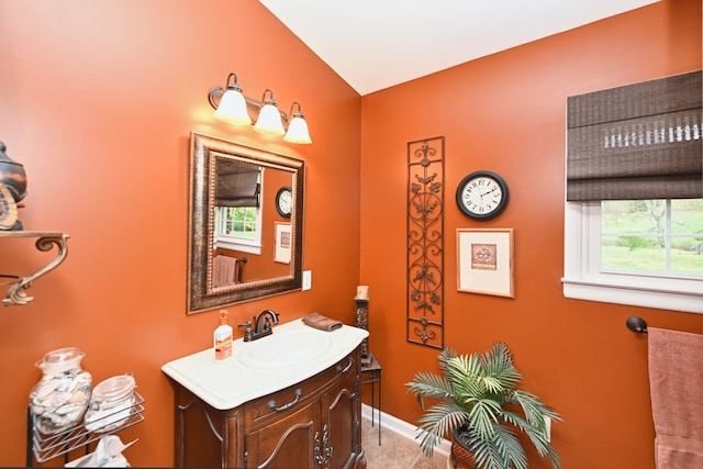 bathroom featuring vanity and vaulted ceiling