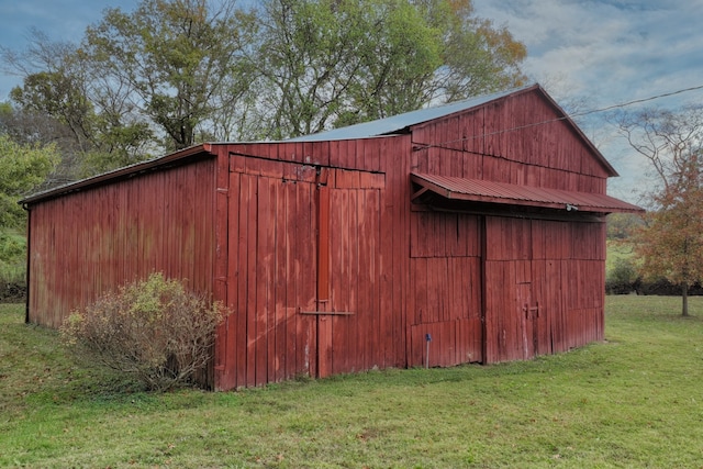 view of outdoor structure featuring a lawn