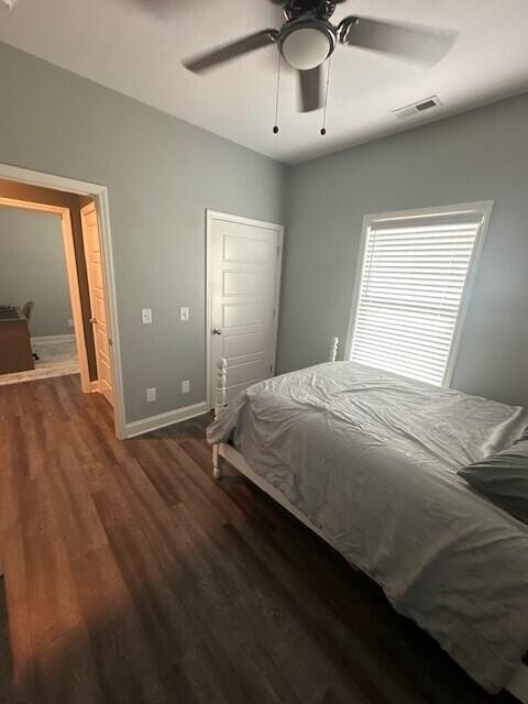 bedroom with dark wood-type flooring and ceiling fan