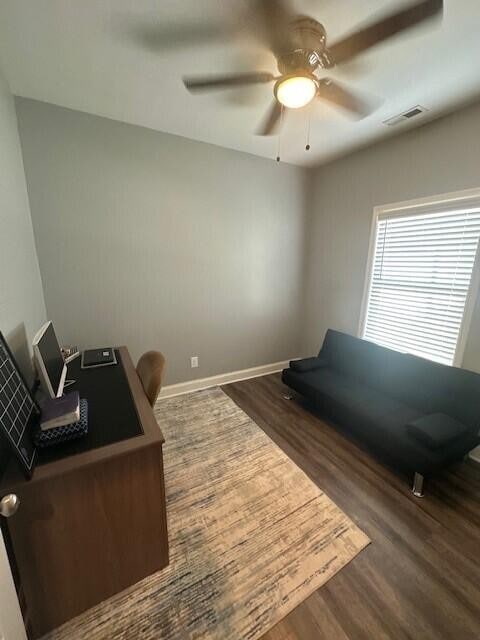 office area featuring dark wood-type flooring and ceiling fan