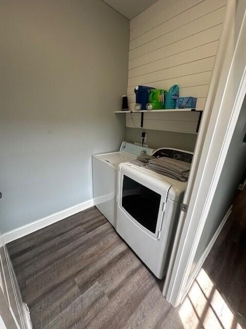 clothes washing area with hardwood / wood-style floors and separate washer and dryer