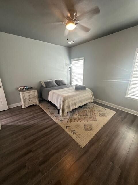 bedroom with ceiling fan and dark hardwood / wood-style flooring