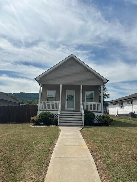 bungalow featuring a front yard and covered porch