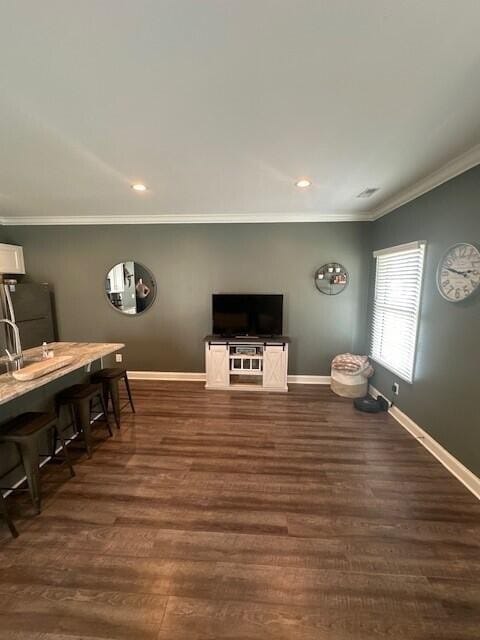 living room featuring crown molding and dark hardwood / wood-style floors