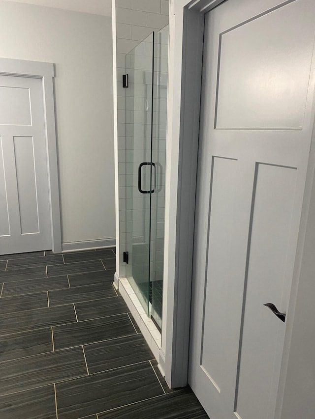 bathroom featuring a shower with door