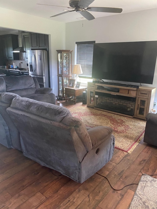 living room featuring dark hardwood / wood-style floors and ceiling fan