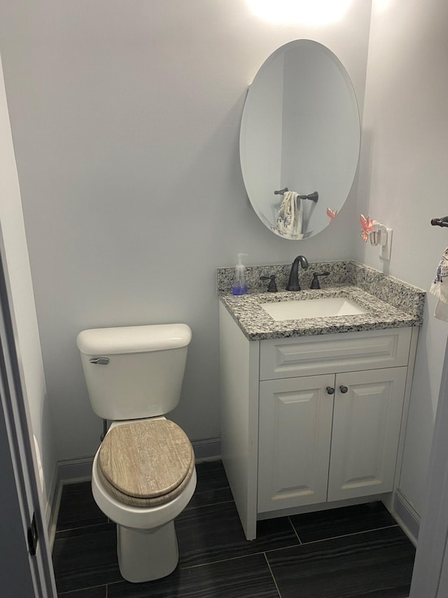 bathroom featuring vanity and toilet