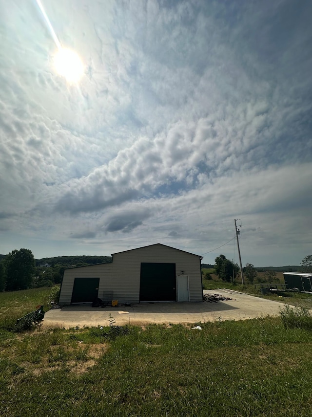 view of outbuilding with a yard and a garage