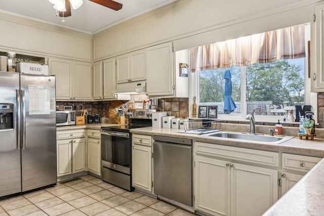 kitchen with light tile patterned floors, appliances with stainless steel finishes, sink, and decorative backsplash