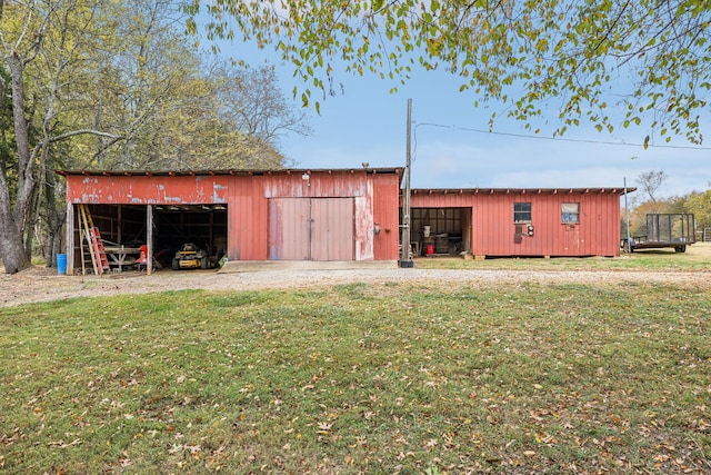 view of outbuilding featuring a lawn