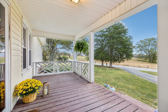 wooden deck with a yard and a porch