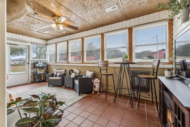 sunroom featuring ceiling fan