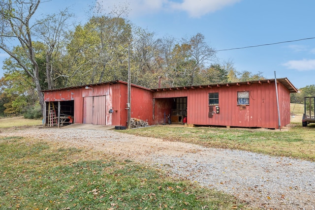 view of outbuilding featuring a lawn