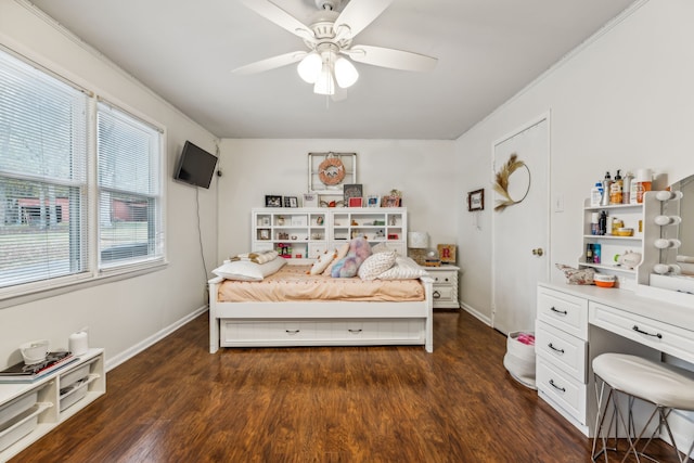 bedroom featuring dark hardwood / wood-style flooring, crown molding, and ceiling fan