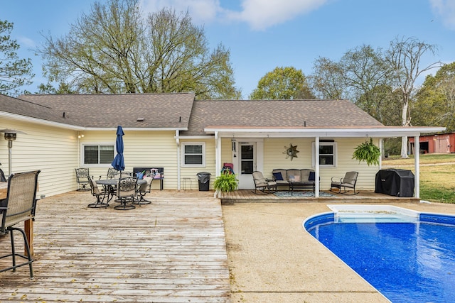 rear view of house with outdoor lounge area and a pool side deck