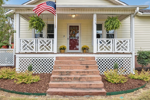 view of exterior entry with a porch