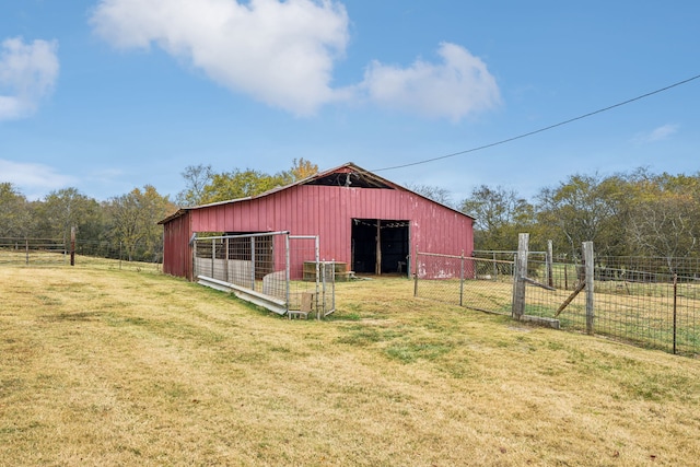 view of outbuilding with a yard