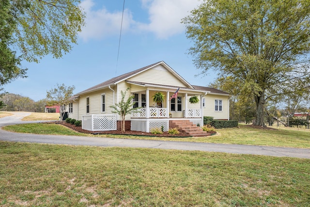 view of front of house with a porch and a front lawn