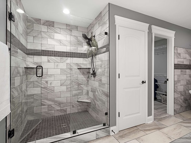 bathroom with a shower with door