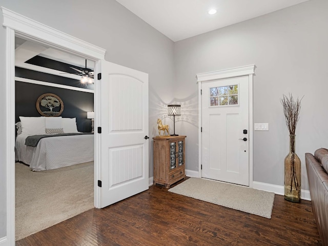 foyer entrance with dark hardwood / wood-style floors and ceiling fan