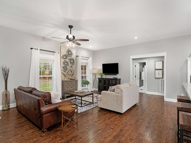 living room with dark hardwood / wood-style floors and ceiling fan