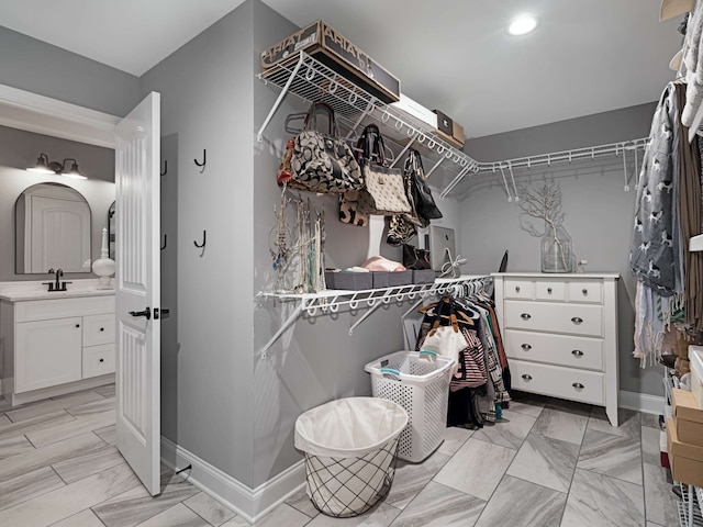 spacious closet featuring sink